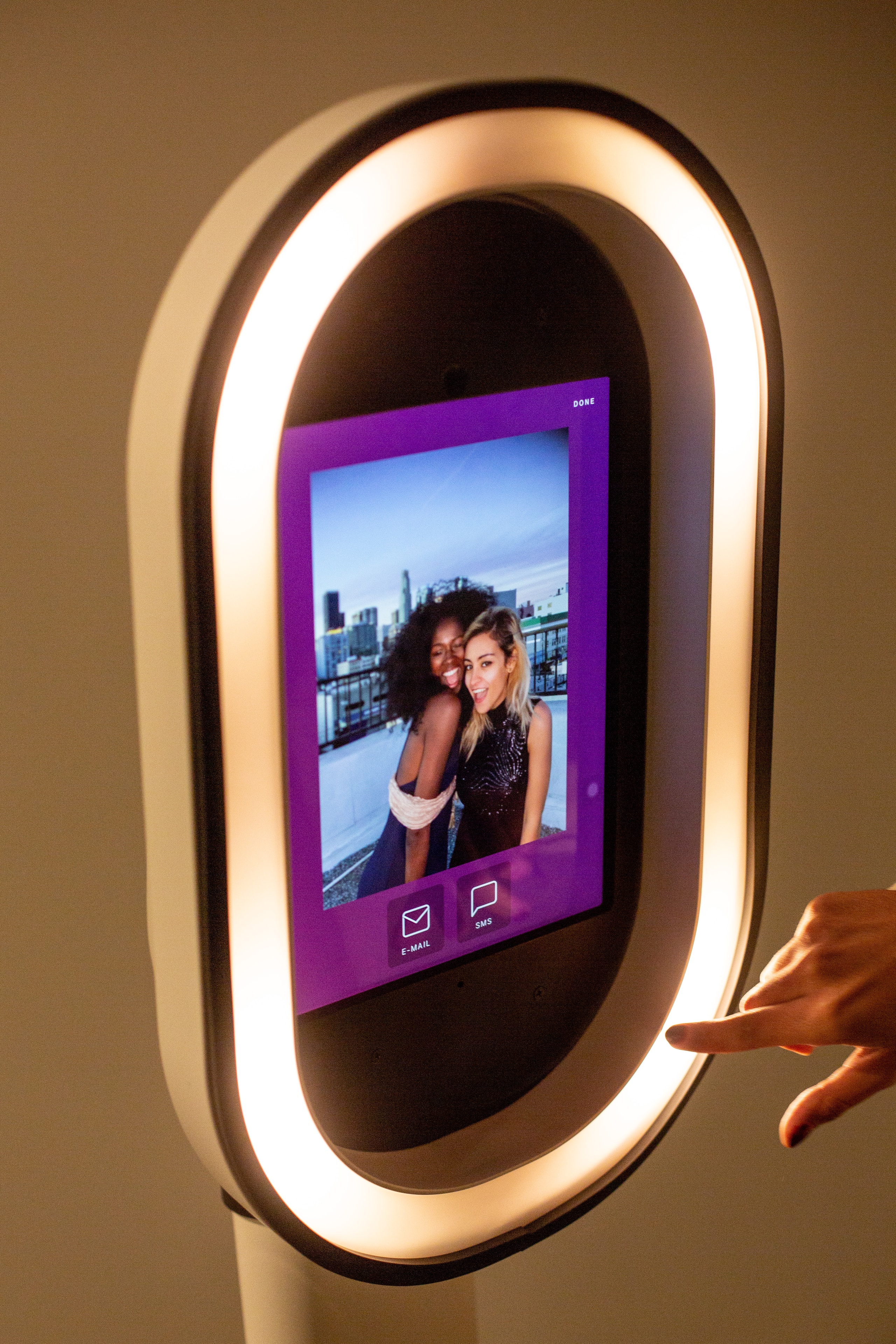 Guests gathered around a GrinBin photo booth outdoors